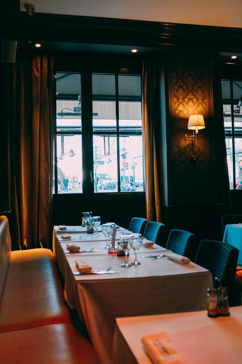 Cozy restaurant interior with a beautifully set dining table and ambient lighting.